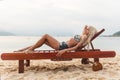 Pretty young slim woman on beach near blue clean water Royalty Free Stock Photo