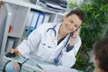 Pretty young smiling female doctor on phone Royalty Free Stock Photo