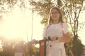 Pretty young smiling girl student riding blue electric kick scooter Royalty Free Stock Photo