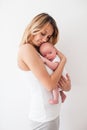 Pretty young smiling mother holding newborn baby Royalty Free Stock Photo