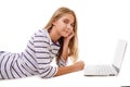 Pretty young teen girl laying on the floor using laptop isolated Royalty Free Stock Photo
