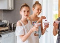 Pretty young teen making a fruit smoothie in the kitchen Royalty Free Stock Photo