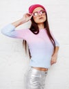 Pretty young teenage girl hipster in pink glasses and hat emotional posing happy smiling, lifestyle people concept Royalty Free Stock Photo