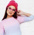 Pretty young teenage girl hipster in pink glasses and hat emotional posing happy smiling, lifestyle people concept Royalty Free Stock Photo