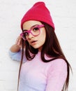 Pretty young teenage girl hipster in pink glasses and hat emotional posing happy smiling, lifestyle people concept Royalty Free Stock Photo