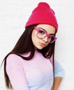 Pretty young teenage girl hipster in pink glasses and hat emotional posing happy smiling, lifestyle people concept Royalty Free Stock Photo