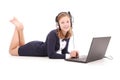 Pretty young teenage girl with laptop and headphones lying on the floor Royalty Free Stock Photo