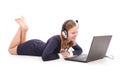 Pretty young teenage girl with laptop and headphones lying on the floor Royalty Free Stock Photo