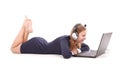 Pretty young teenage girl with laptop and headphones lying on the floor Royalty Free Stock Photo