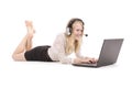 Pretty young teenage girl with laptop and headphones lying on the floor Royalty Free Stock Photo
