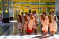 Pretty young teenage nuns in pink uttarasanga visiting Shwethalyaung reclining buddha temple in Bago Pegu, Myanmar