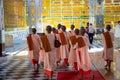 Pretty young teenage nuns in pink uttarasanga visiting Shwethalyaung reclining buddha temple in Bago Pegu, Myanmar