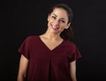 Pretty young toothy enjoying smiling woman with long brown healthy curly hair style in dark red blouse clothing on studio Royalty Free Stock Photo