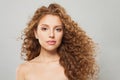 Pretty young wavy hair woman. Fashion model with long curly hairstyle and natural fresh clear skin posing on white background Royalty Free Stock Photo