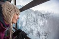 Pretty, young woman admiring splendid winter scenery