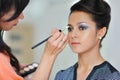 Pretty young woman applying makeup by makeup artist Royalty Free Stock Photo