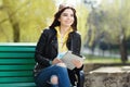 Pretty young woman with beautiful smile using tablet in the park at the sunset. Royalty Free Stock Photo