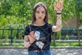 Pretty young woman behind fence, young woman in a park Royalty Free Stock Photo