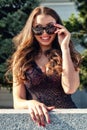 Pretty young woman with big breast and smiling face looking through sunglasses Royalty Free Stock Photo