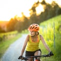 Pretty, young woman biking on a mountain bike Royalty Free Stock Photo