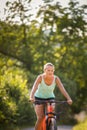 Pretty, young woman biking on a mountain bike