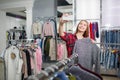 Young beautiful women posing on camera in a cloth market. Royalty Free Stock Photo