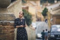 Pretty young woman in a black dress using smartphone at old town street. Travel by Europe. Toledo, Spain Royalty Free Stock Photo