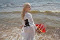 Pretty young woman with blonde hair on sea, outdoor portrait Royalty Free Stock Photo