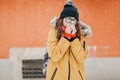 Young woman blowing her nose with a tissue outdoor in winter. Young woman getting sick with flu in a winter day Royalty Free Stock Photo