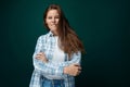 A pretty young woman with brown eyes is wearing a checkered blue shirt and looks confidently at the camera Royalty Free Stock Photo