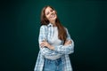 A pretty young woman with brown eyes is wearing a checkered blue shirt and looks confidently at the camera Royalty Free Stock Photo