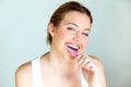 Pretty young woman brushing her teeth in the bathroom at home. Royalty Free Stock Photo