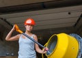 Pretty young woman builder and concrete mixer Royalty Free Stock Photo