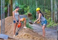 Pretty young woman builder digging a shovel Royalty Free Stock Photo