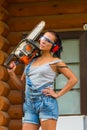 Pretty young woman builder with powered chain saw Royalty Free Stock Photo