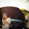 Pretty, young woman calling the roadside service Royalty Free Stock Photo