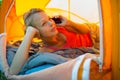 Pretty, young woman camping outdoors Royalty Free Stock Photo