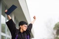 Pretty, young woman celebrating joyfully her graduation Royalty Free Stock Photo