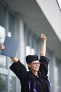 Pretty, young woman celebrating joyfully her graduation Royalty Free Stock Photo