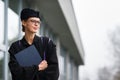 Pretty, young woman celebrating joyfully her graduation Royalty Free Stock Photo