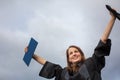 Pretty, young woman celebrating joyfully her graduation Royalty Free Stock Photo