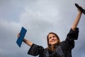 Pretty, young woman celebrating joyfully her graduation Royalty Free Stock Photo