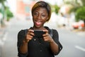 Pretty young woman on cellphone on school campus Royalty Free Stock Photo