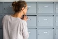 Pretty, young woman checking her mailbox Royalty Free Stock Photo
