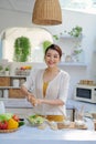 Pretty young woman chef putting salt in a salad Royalty Free Stock Photo