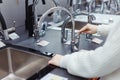 Pretty young woman choosing a bathroom/kitchen tap in a home furnishings retail store Royalty Free Stock Photo