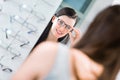 Pretty, young woman choosing new glasses frames Royalty Free Stock Photo