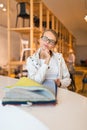 Pretty young woman choosing the right material/color for her modern appartement interior