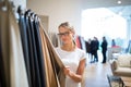 Pretty young woman choosing the right material/color for her modern appartement interior