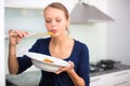Pretty, young woman cooking a diner in a modern kitchen Royalty Free Stock Photo
